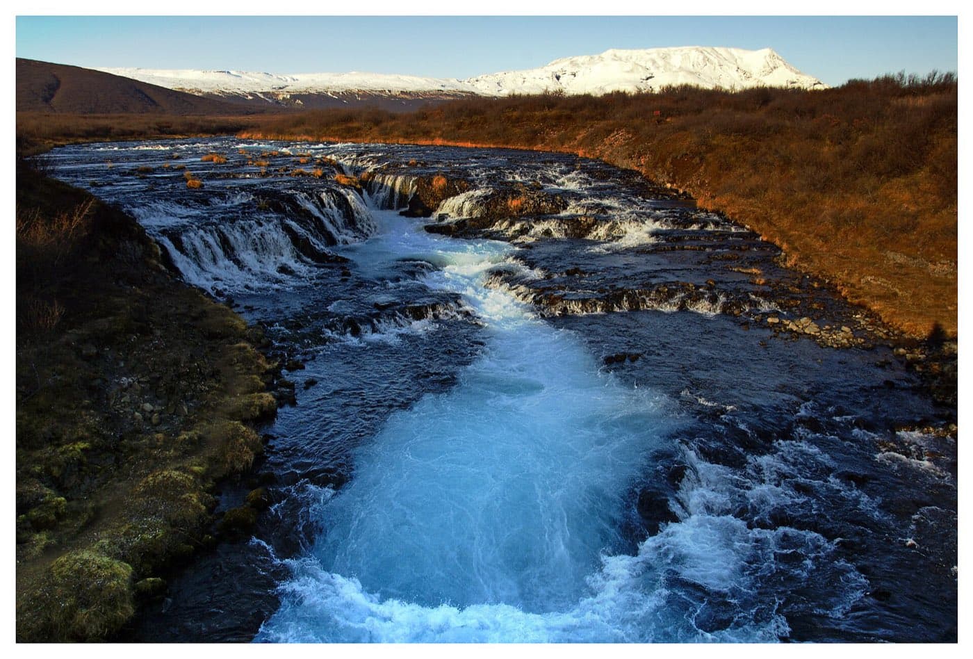 The bright turquoise water of Bruarfoss waterfall