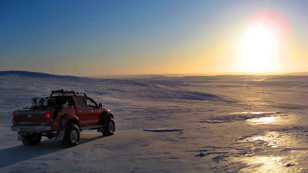 A four-wheel-drive vehicle parked on a snow-covered glacier