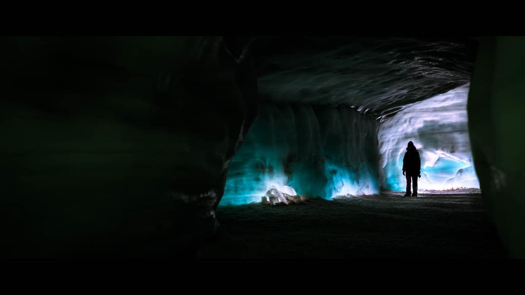 Visitors walking a lit passage inside the Langjokull ice tunnel