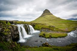 The cone of Mount Kirkjufell beside Kirkjufellsfoss waterfall