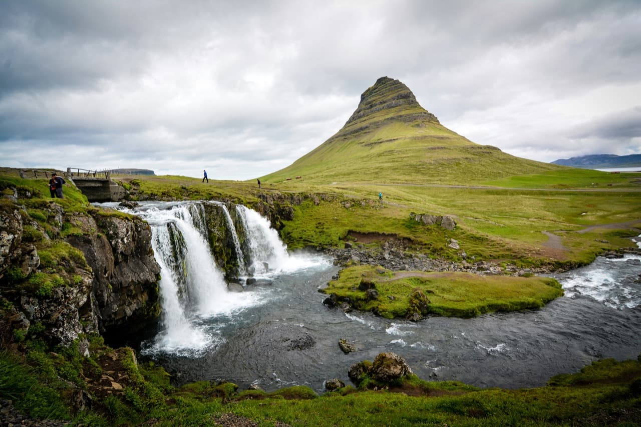 The cone of Mount Kirkjufell beside Kirkjufellsfoss waterfall