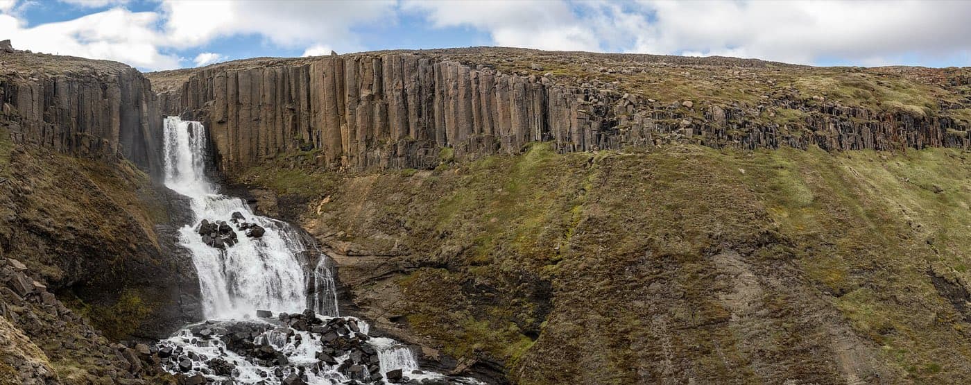 Basalt columns lining the green river in Studlagil canyon